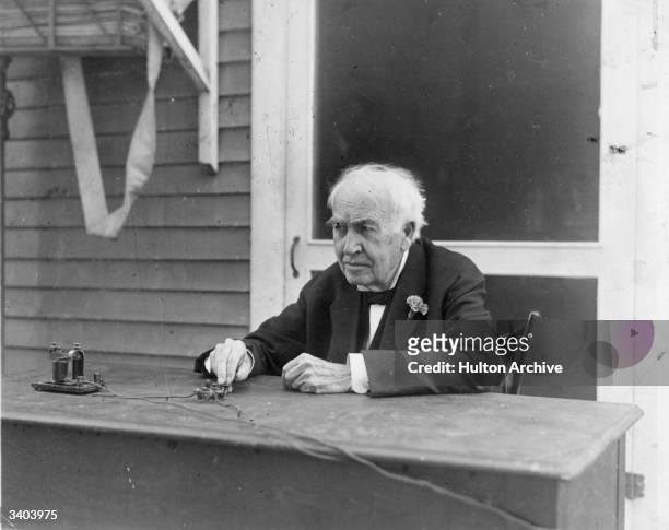 Inventor Thomas Alva Edison operating a telegraph key on his 81st birthday. The key he is pressing is actually inaugurating a modern Elison lighting...
