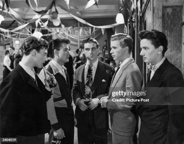 Young actor Ian Whittaker confronts James Kenney in the presence of the Cosh gang, played by Stanley E Scane, Sean Lynch and John Briggs, in a scene...