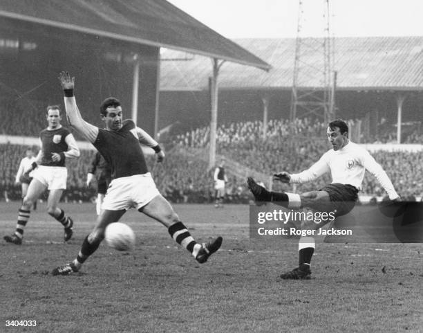 Tottenham Hotspur's Jimmy Greaves has a shot at goal blocked by Burnley defender, Joyce, during a match at White Hart Lane.