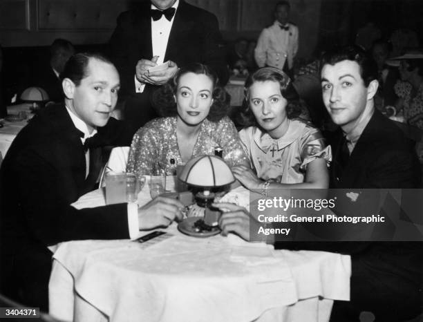 Joan Crawford the screen name of Lucille Le Sueur, also known as Billie Cassin, with husband Franchot Tone, Barbara Stanwyck and Robert Taylor. They...