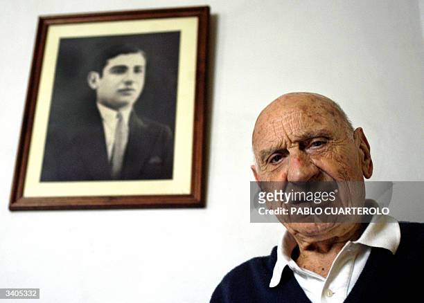 Argentinian ex soccer player Francisco "Pancho" Varallo poses with a portrait of himself on the time he played for Boca Juniros, at his house in La...