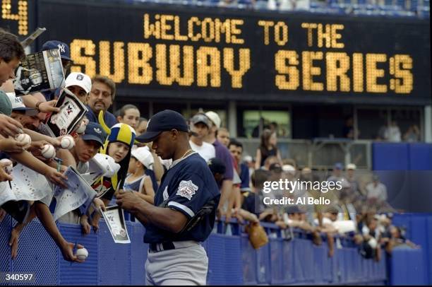 Orlando Hernandez of the New York Yankees signes autographes for fans prior to the Subway Series an Interleague game against the New York Mets at...