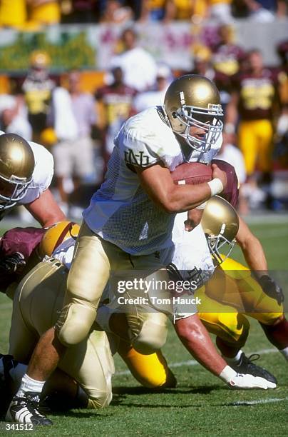 Fullback Joey Goodspeed of the Notre Dame Fighting Irish grips the ball as he runs during the game against the Arizona State Sun Devils at Sun Devil...