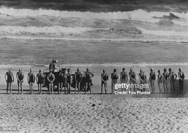 Queen Elizabeth II of Great Britain and the Duke of Edinburgh driving along Bondi Beach and inspecting life saver teams during a royal tour of...