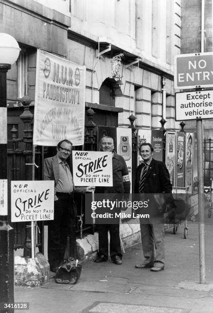 Officials on picket duty outside Paddington Station, London, during the rail drivers strike.