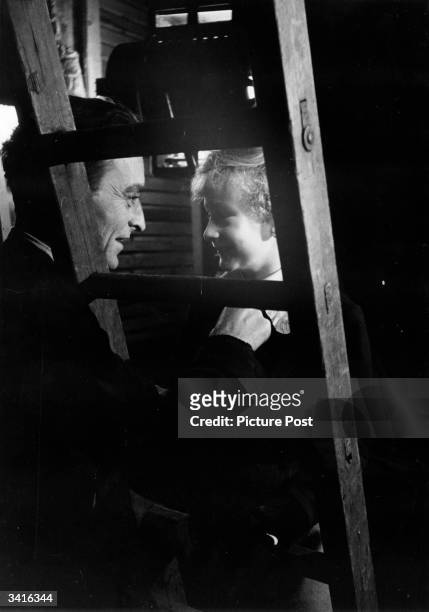 Director David Lean coaches young star John Howard Davies for a scene in his film adaptation of 'Oliver Twist'. Original Publication: Picture Post -...