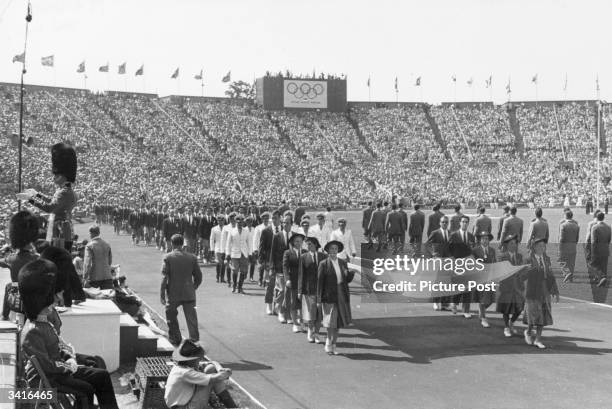 Athletes parading during the Opening Ceremony of the Olympic Games at Wembley Stadium. Original Publication: Picture Post - 4582 - Our Welcome To...