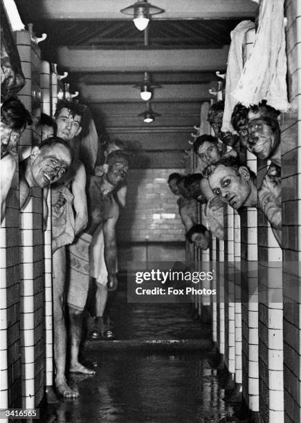 Miners taking a shower following a shift down the coal pit.