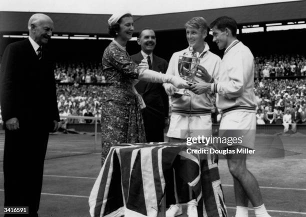 The Duchess of Kent presents the men's singles trophy to Lew Hoad after his victory over fellow Australian Ken Rosewall at the Wimbledon Lawn Tennis...