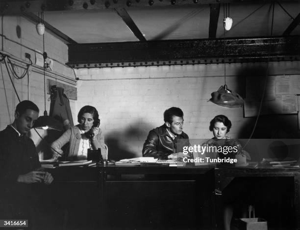 Sir Anton Dolin , Britain's first male premier dancer and founder of the Markova-Dolin Company, on duty in a bunker as air raid warden during World...