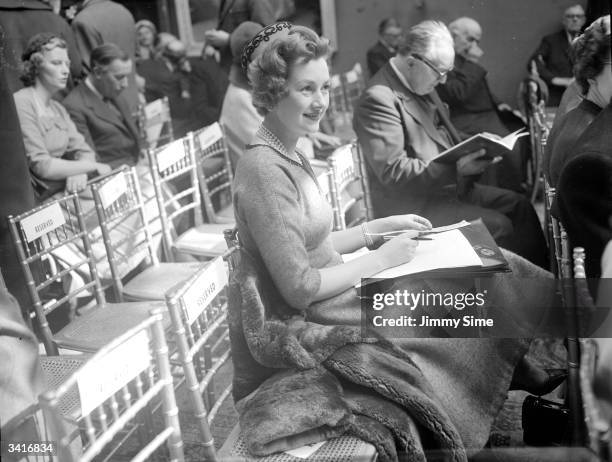 Raine, Lady Lewisham, later the wife of Earl Spencer, in the audience at a Sotheby's auction.