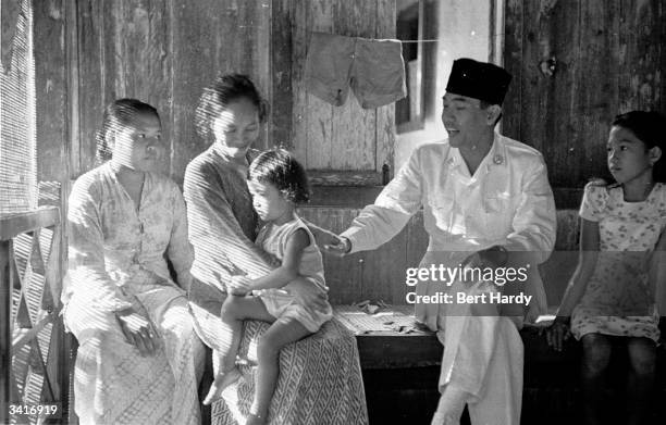 Indonesian president, Achmed Soekarno , greeting people on the island of Banka, where he has been detained by the Dutch authorities. Original...