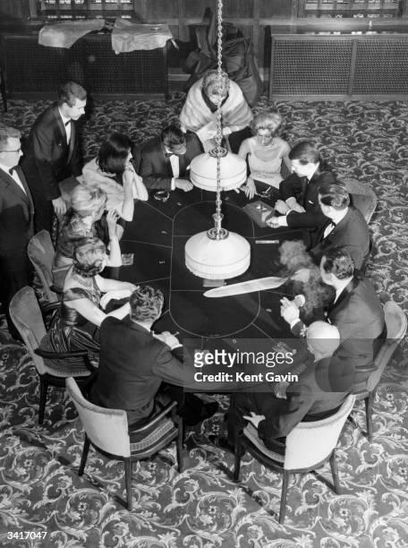 Playing Chemin de fer a form of baccarat in a gaming room at the Playboy Club, an exclusive residential country club in Barnet, north London. No...