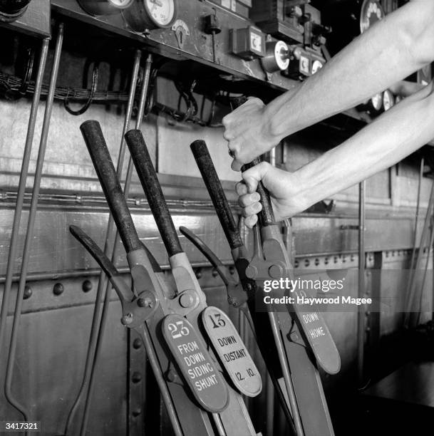 Some of the many levers in one of the many signal boxes that control the routes of trains along Britain's railways. Original Publication: Picture...