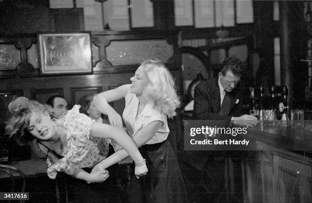Jim Nolan, just released from prison, ignores his wife who is attacking a woman he was with in the pub. From a Picture Post fictional serial about...