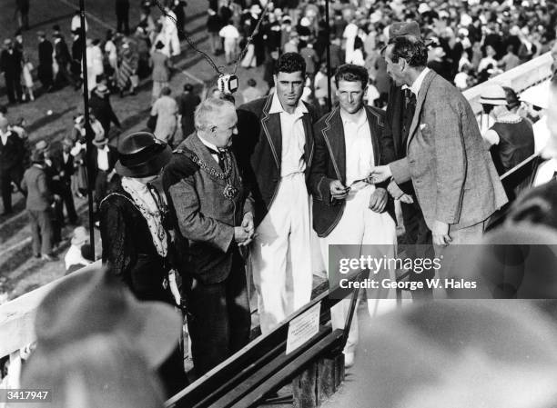 England cricket captain Douglas Jardine presents certificates to England and Nottinghamshire Cricketers Harold Larwood and Bill Voce at Trent Bridge,...