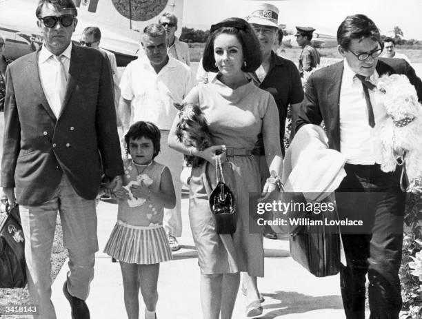 Actor Richard Burton arrives in Mexico to film 'Night of the Iguana', accompanied by his future wife Elizabeth Taylor and her daughter Liza Todd.