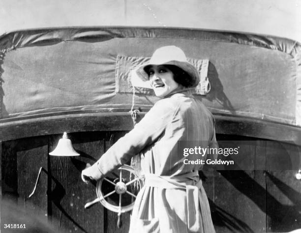 Actress Pauline Frederick driving the motor launch which appears in her latest film, 'Bonds of Love'.