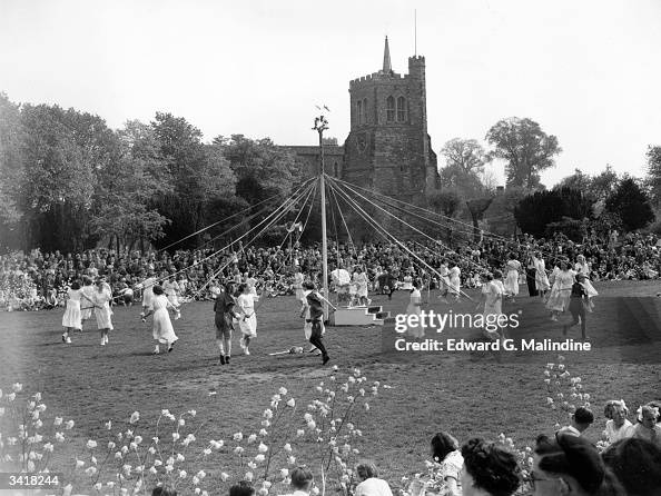 Maypole dancers dancing around a maypole during May Day celebrations ...