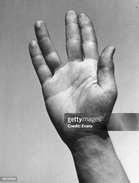 Close-up of a hand signaling a Vulcan salute from the television series 'Star Trek'.