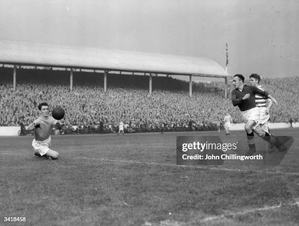 Celtic goalkeeper, Miller, dives for the ball during a Rangers attack, as Celtic play Glasgow Rangers in the Glasgow derby at Ibrox. Large crowds...