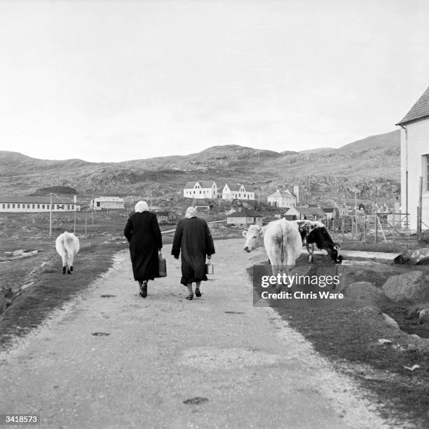 Two women walking on a road on the island of Barra in the Outer Hebrides. Barra, named after St Barr, is the most southerly island in the Hebrides...