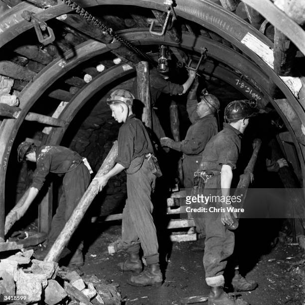 Teenage boys studying at the National Coal Board's school at Dungavel House in Lanarkshire learning how to erect pit props in a tunnel at a nearby...