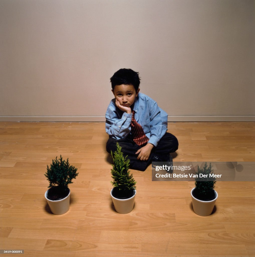 Boy near Row of Plants