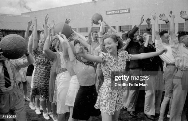 Holidaymakers keep fit whilst playing with balls at Butlin's Holiday Camp, Skegness, Lincolnshire. Original Publication: Picture Post - 193 - Holiday...