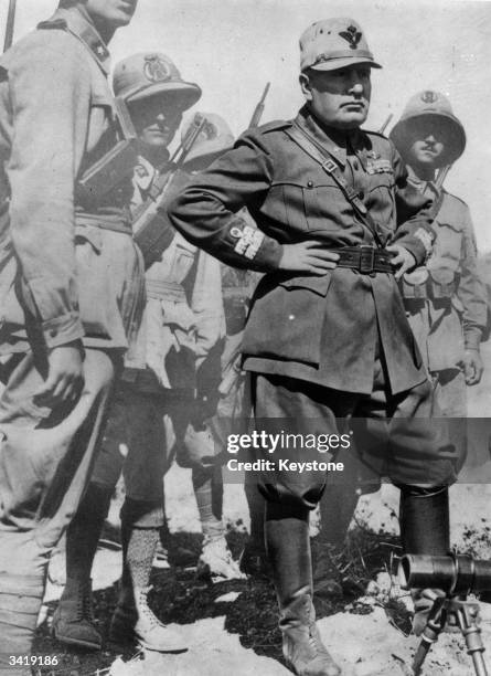 Dictator Benito Mussolini , on a visit to inspect Italian troops in a North African battle zone, a few weeks before the beginning of a new British...