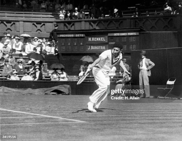 French tennis player Jean Borotra in action against H Henkel of Germany on centre court at the Wimbledon Lawn Tennis Championships.