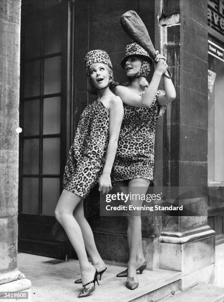 Modelling leopard skin dresses and matching hoods, designed by Edward Mann.