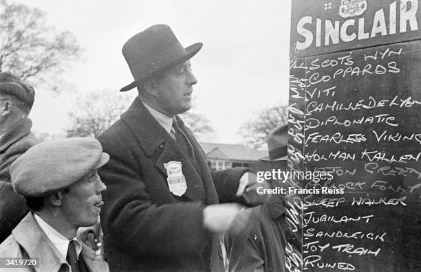 Ex-serviceman John Driscoll writing up the odds in his new job as a bookmaker. Original Publication: Picture Post - 4283 - What's Become Of Them Now?...