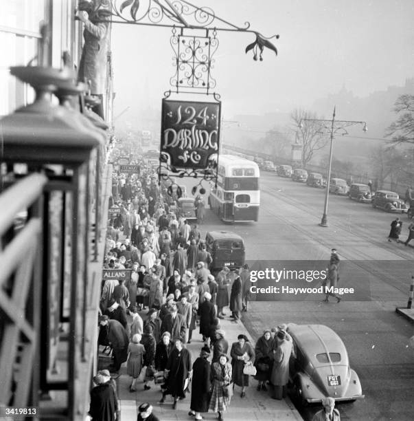 Princes Street, Edinburgh, busy with shoppers. Princes Street, named after George III's sons, was designed by James Craig who built hotels and shops...