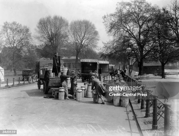Volunteers load milk churns from a central collection point in Hyde Park, London during the General Strike of 1926.