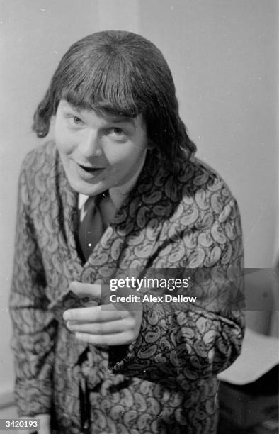 British comedian Benny Hill , in character and wearing a wig. Original Publication: Picture Post - 6849 - The Queen's Champions - pub. 1954