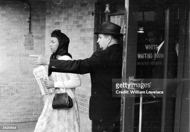 Black woman is directed away from the 'white waiting room' at Jackson, Mississippi, 25th May 1961. She has arrived on the 'Freedom Bus' to protest...