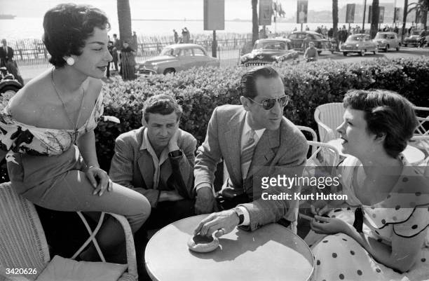 Arthur feels jealous as his new wife makes friends with attractive locals during their honeymoon in the South Of France. From a Picture Post photo...