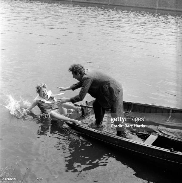 British comedian Frankie Howerd reaches out to a fellow passenger but fails to catch her before she falls in the water. Original Publication: Picture...