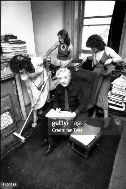 At home in Chelsea, Quentin Crisp has plenty of helpers with the housework.