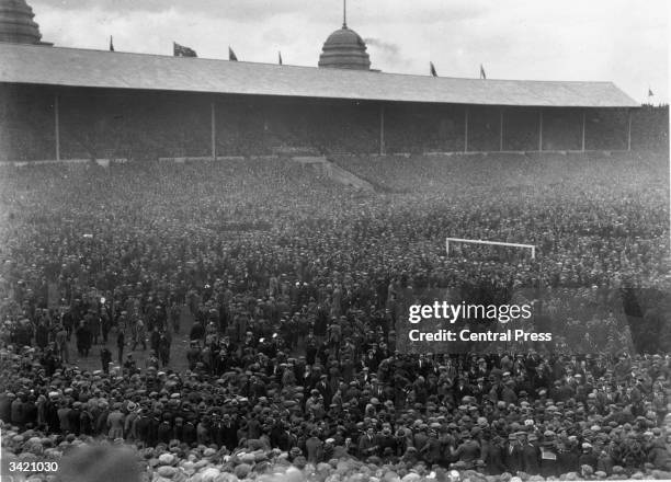 Massive crowd is forced onto the pitch by sheer weight of numbers at the FA Cup Final between Bolton Wanderers and West Ham United. Bolton won the...