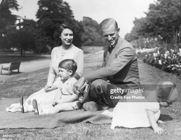 Princess Elizabeth and Prince Philip, Duke of Edinburgh with their two children, Prince Charles and Princess Anne in the grounds of Clarence House,...