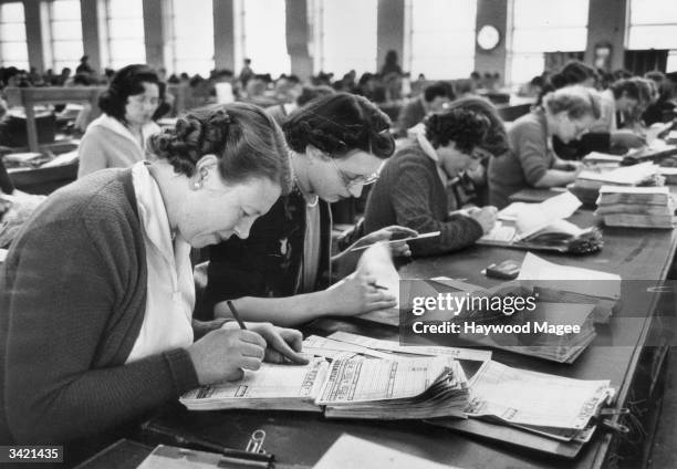 Staff at Littlewoods football pools firm, Liverpool, checking coupons. Original Publication: Picture Post - 7433 - Two Million Pounds A Week - pub....
