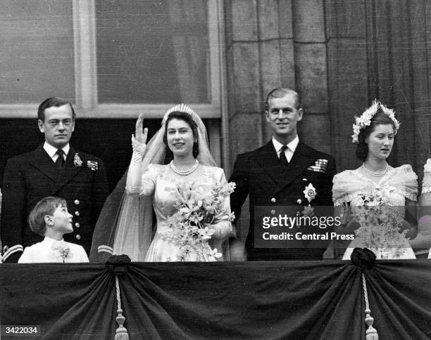 Princess Elizabeth and the Duke of Edinburgh on the balcony of Buckingham Palace, London, waving to the crowd shortly after their wedding at...