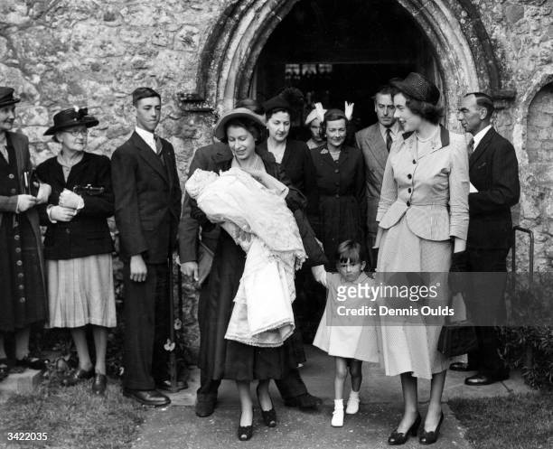 Princess Elizabeth at the christening of the son of Lord and Lady Braborne, at which she acted as godparent. At Mersham Church, Ashford, Kent.