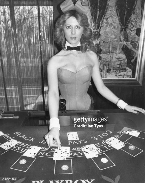 Croupier and bunny girl, Corrina, dealing cards at the Hefner-Playboy Park Lane club in London.