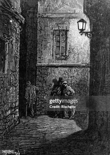 Men standing in an alley lit by a gas street lamp in London. Original Artwork: Engraving by Gustave Dore.