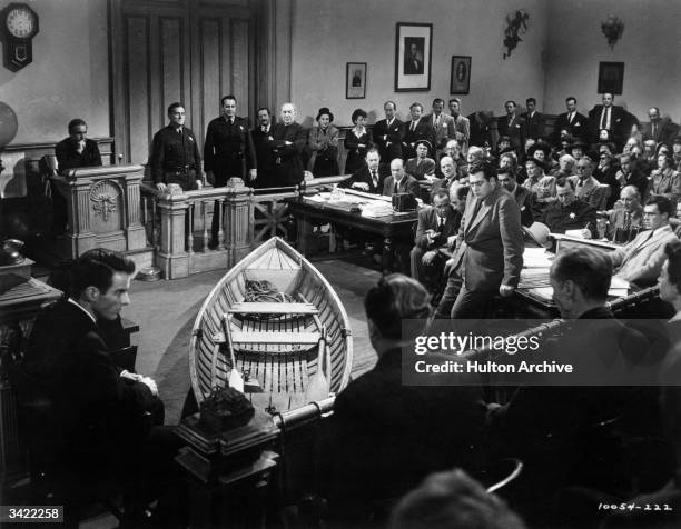 Montgomery Clift and Raymond Burr appear in a courtroom scene from the melodrama 'A Place In The Sun', with the incriminating rowing boat in the...