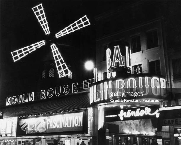 The neon lights of the famous Moulin Rouge nightclub in Paris which opened in 1890.