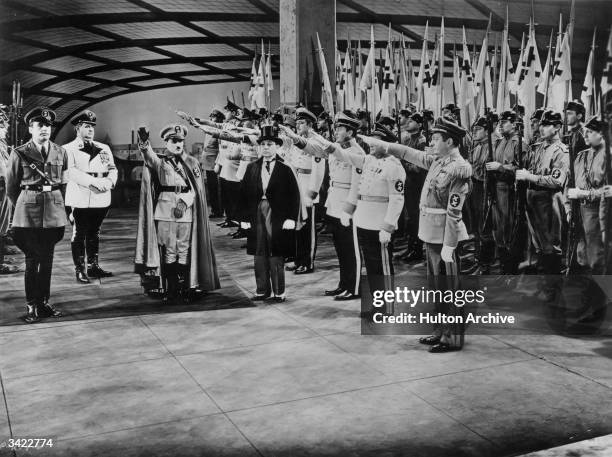 Charlie Chaplin receives a salute from his troops in the United Artists film 'The Great Dictator', directed by Chaplin himself.